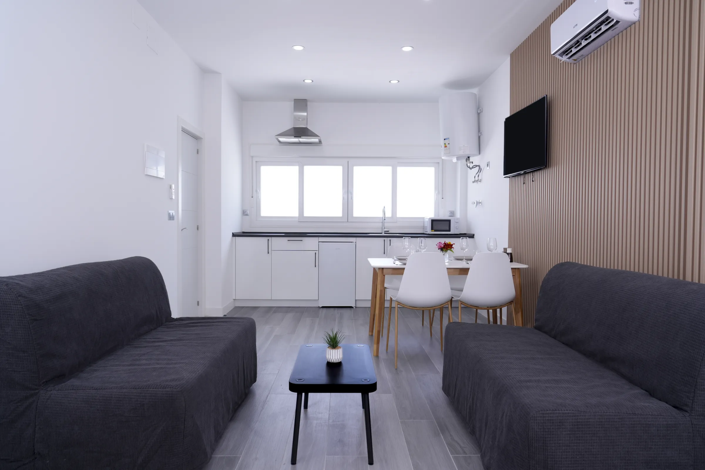 Living room with sofas and kitchen behind