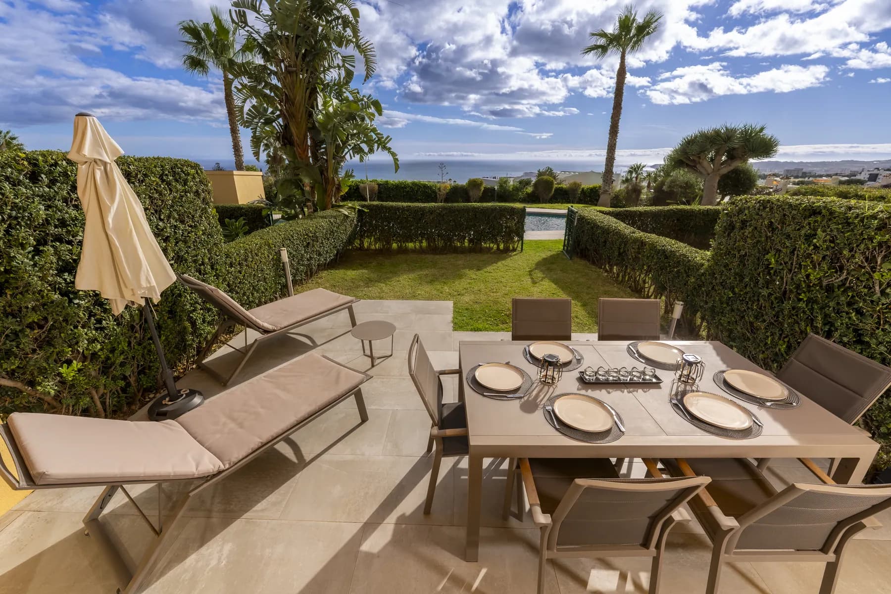 Terrace with sun loungers and garden