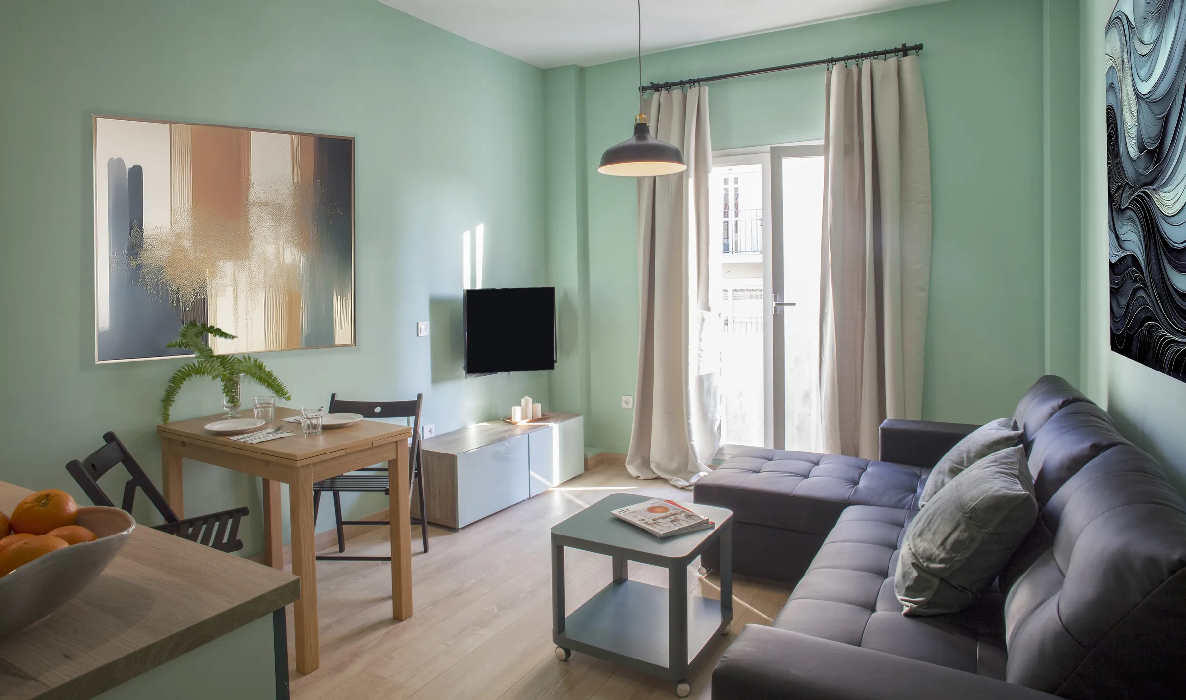 Sea-green living room with chaise-longue sofa and dining table