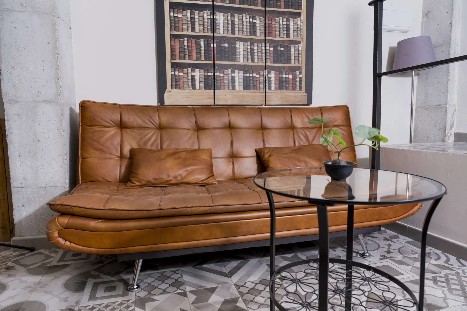 Leather sofa facing the painted bookcase