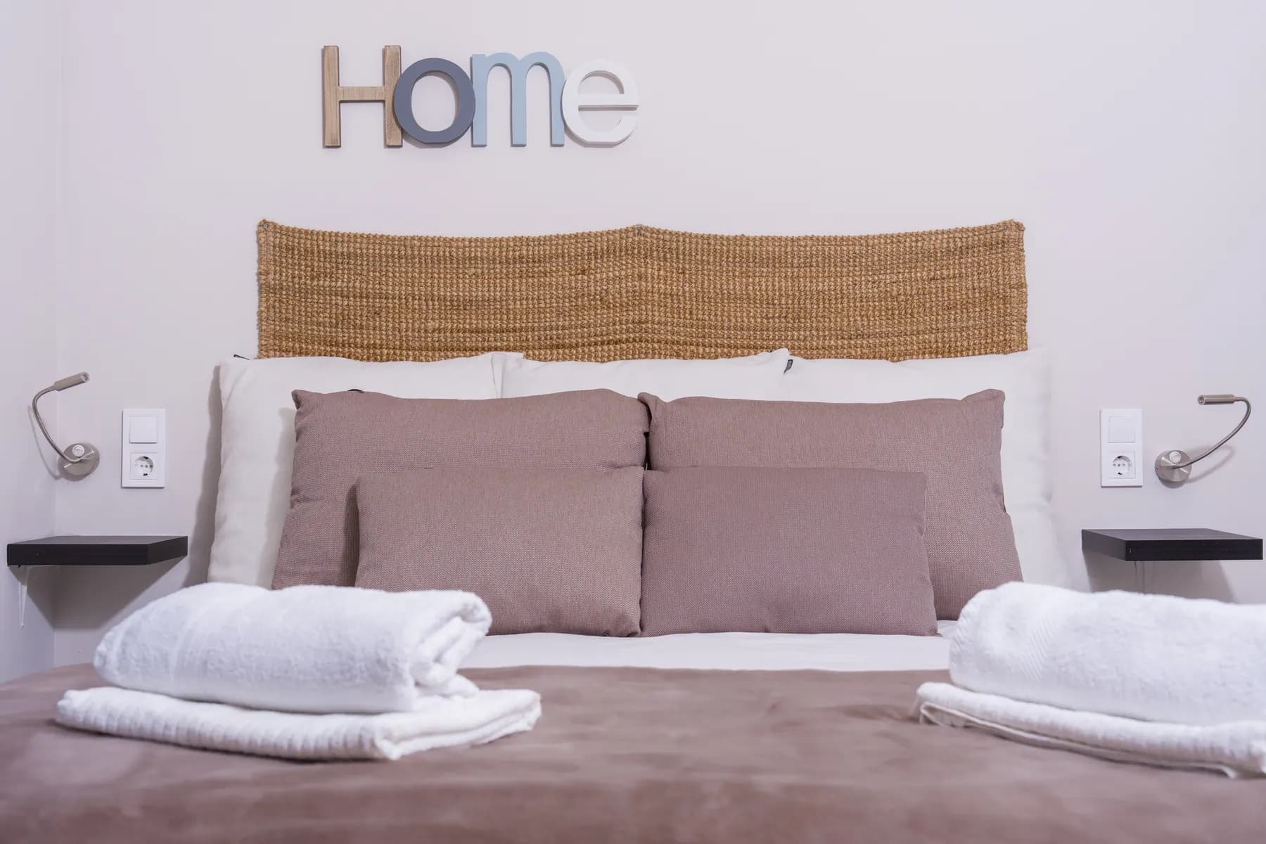 Bed with cushions and towels