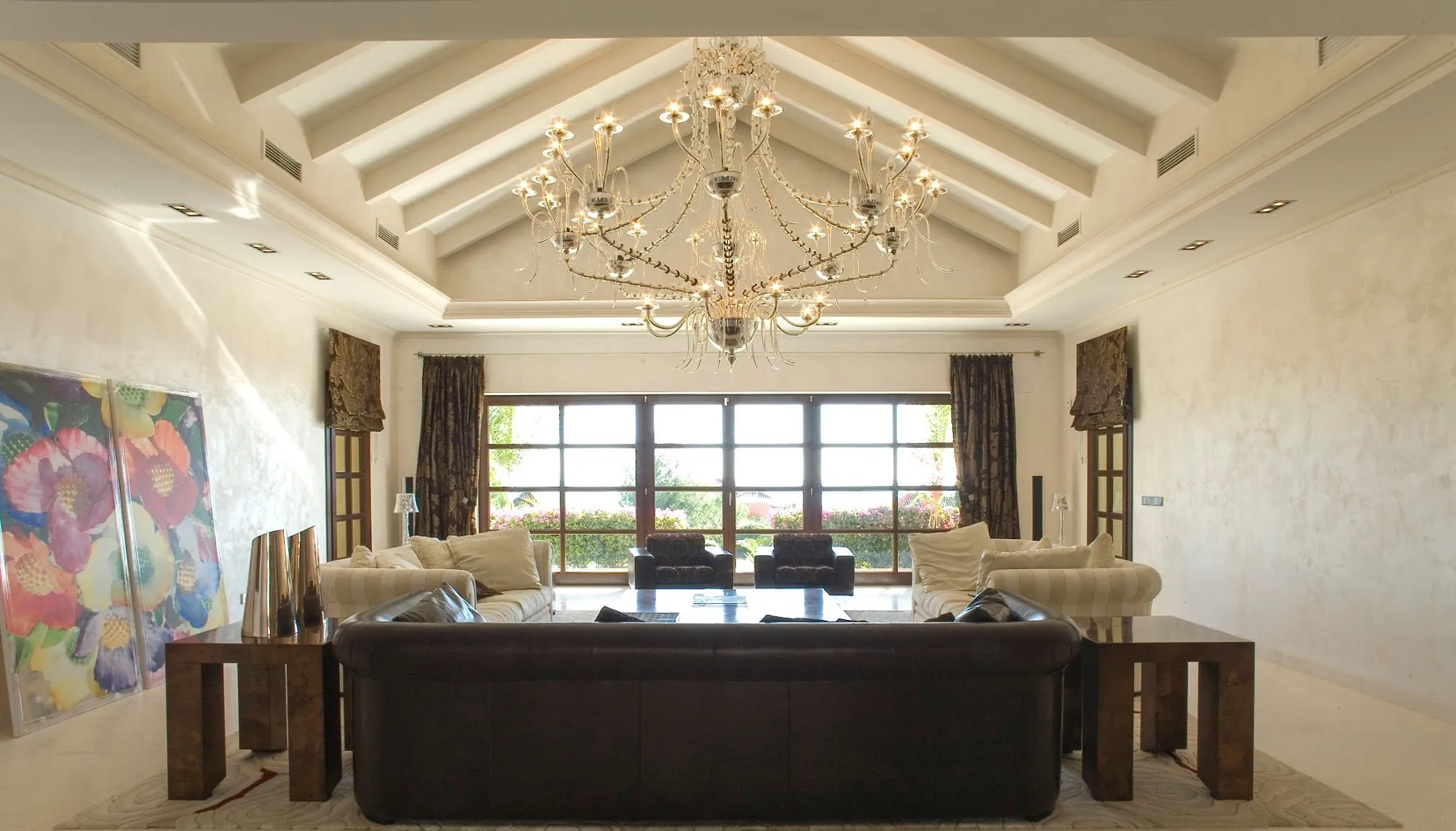 Living room with beamed ceiling and crystal chandelier