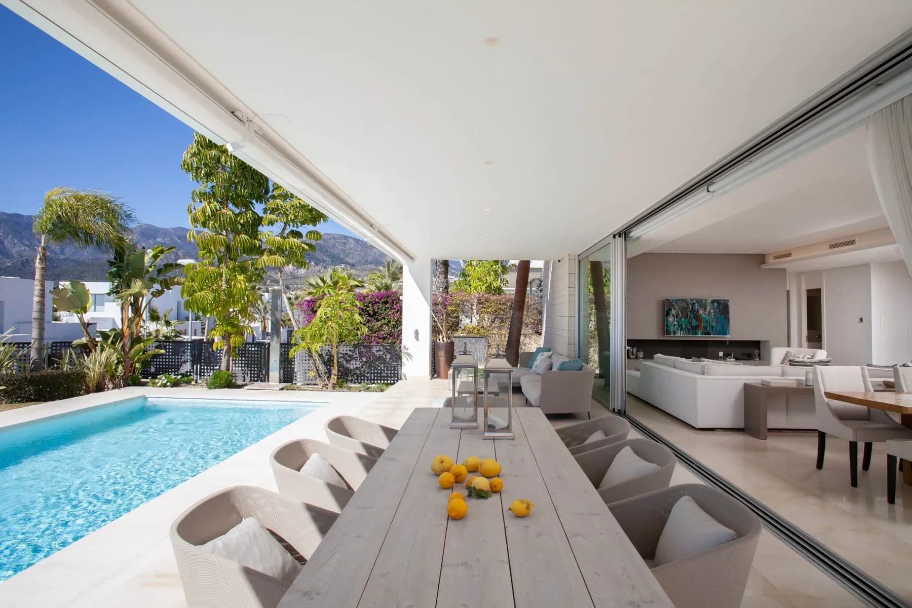 Outdoor dining facing the pool and mountain