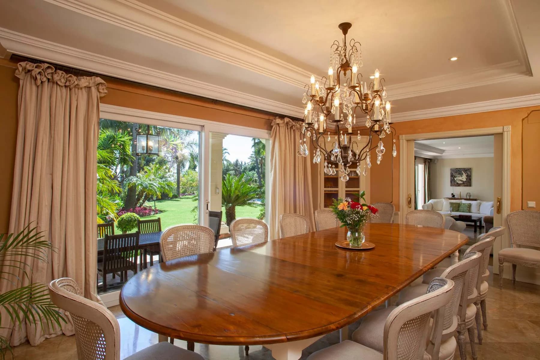 Dining room with chandelier opening onto the garden